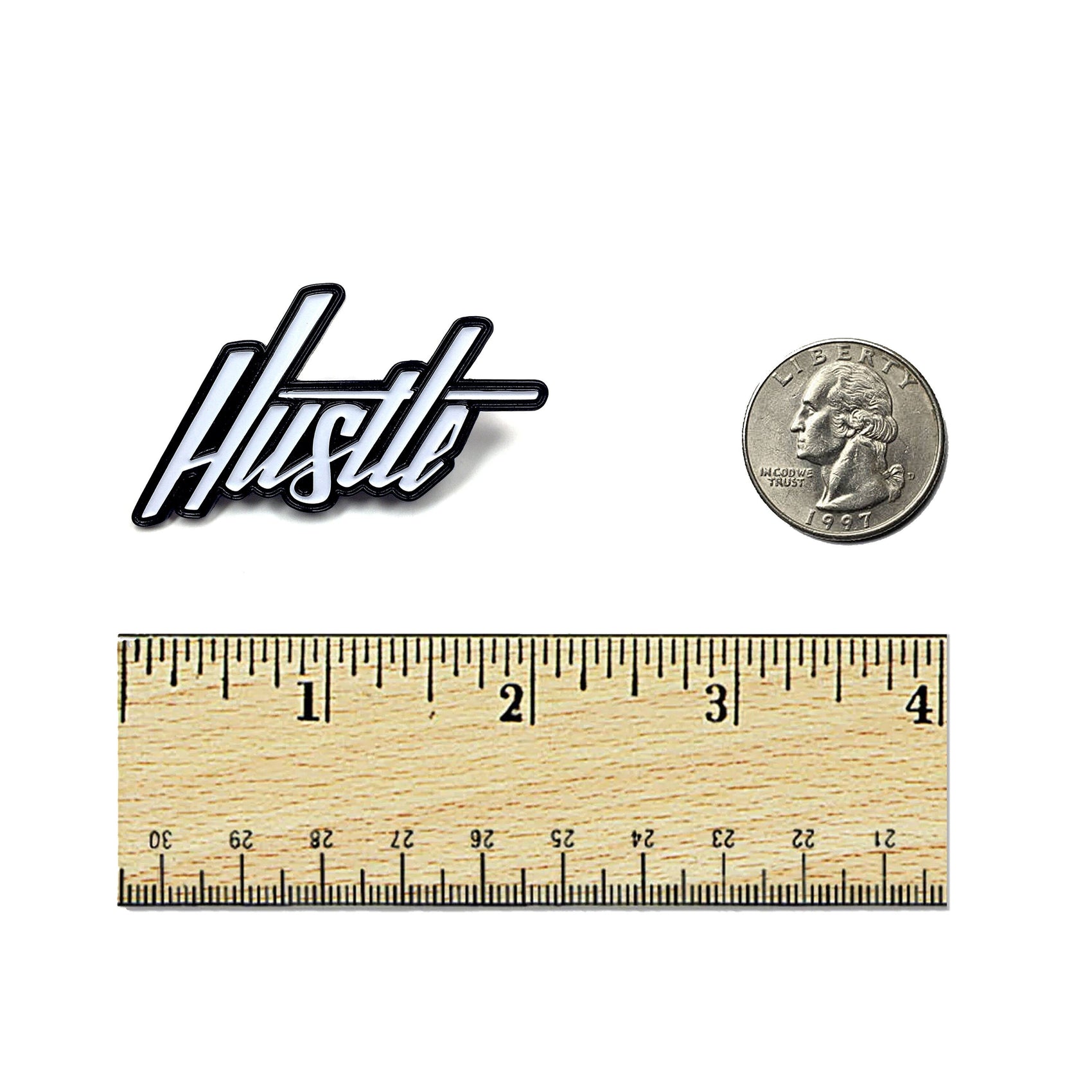 The Kolorspun Hustle Golf Ball Marker, shown beside a U.S. quarter and inch-marked ruler for scale, is a unique custom gift or magnetic marker for golfers.