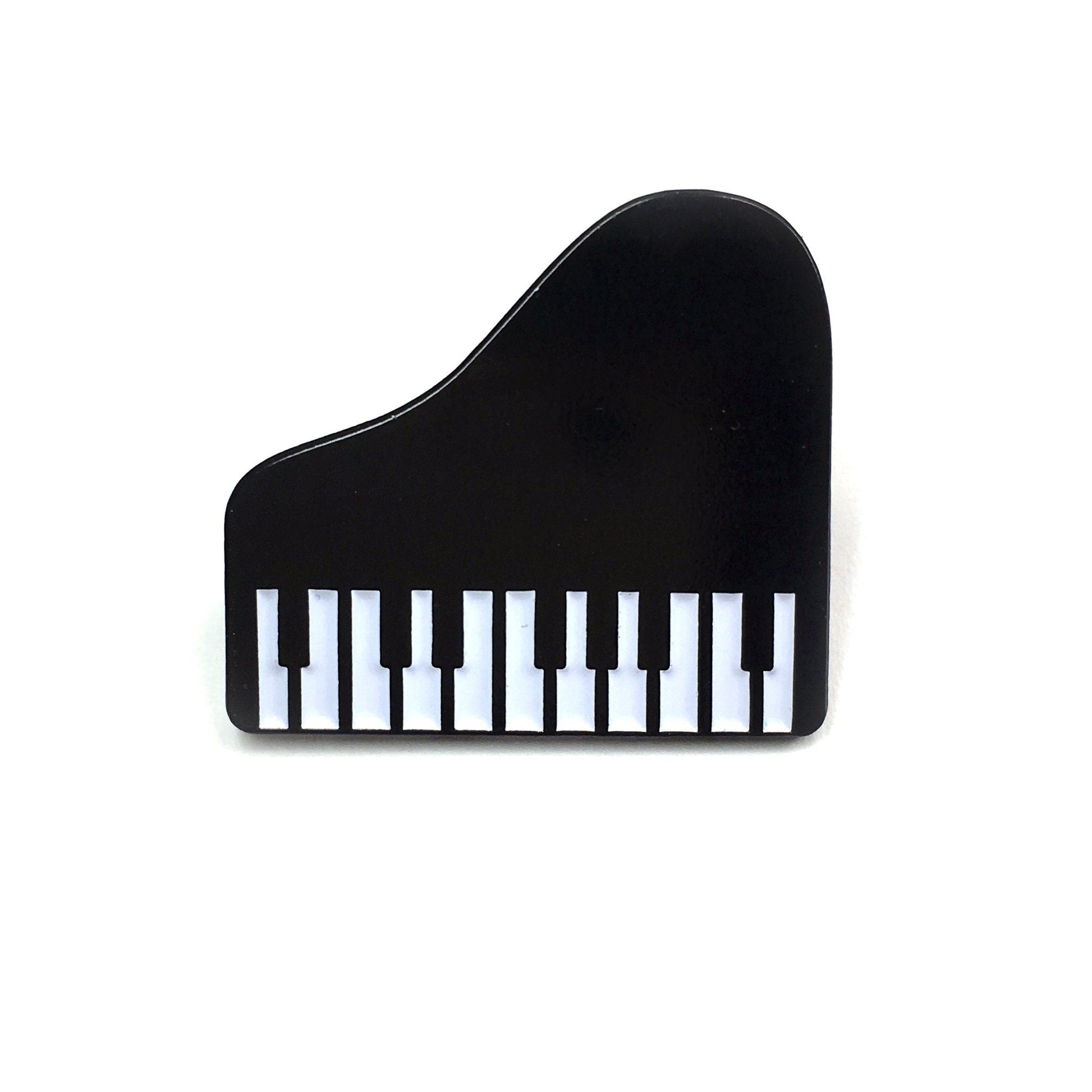 The Kolorspun Piano Golf Ball Marker is a small, black magnetic marker shaped like a grand piano with detailed keys—a unique custom golf gift—shown on a plain white background.