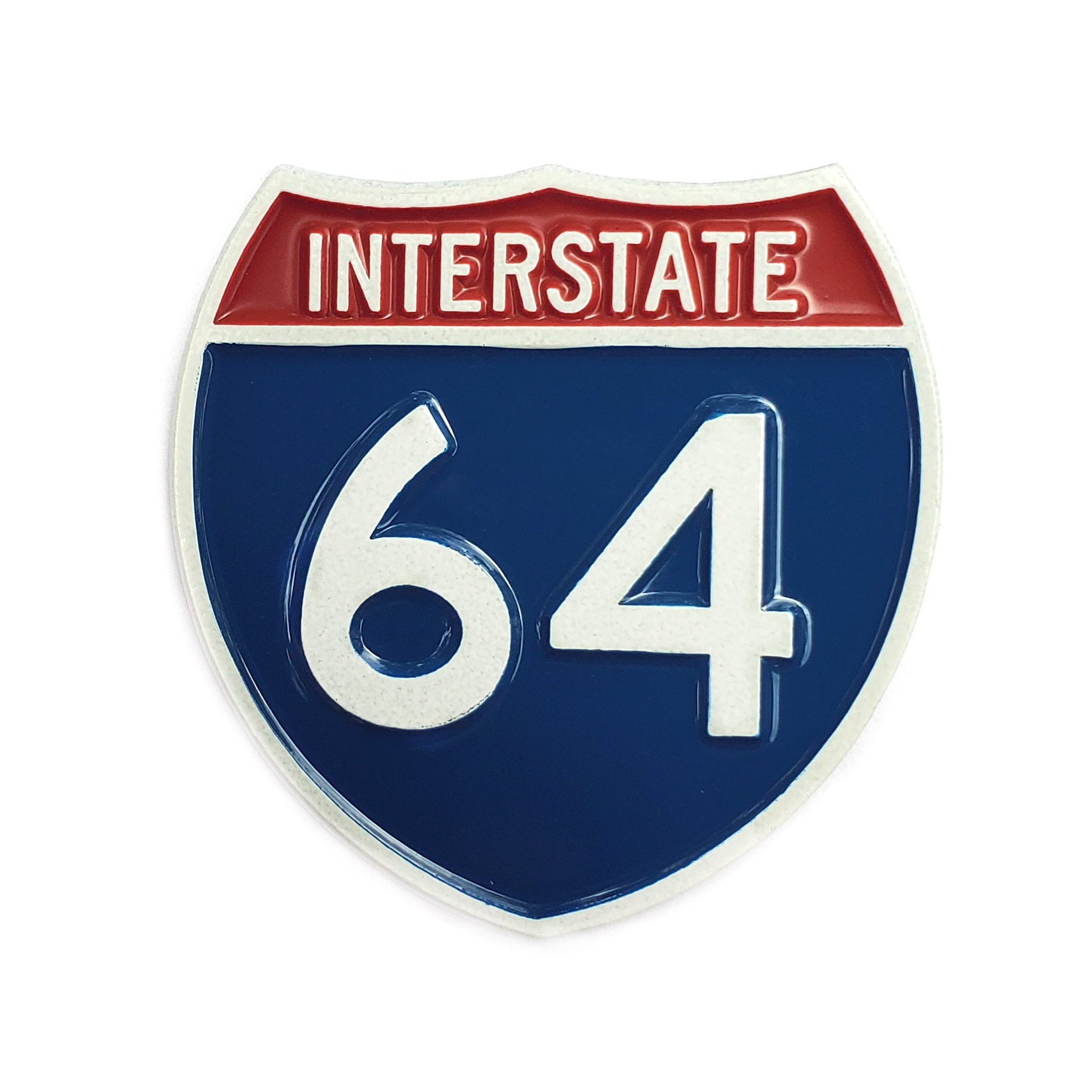 The Kolorspun I64 Golf Ball Marker features a shield design with “INTERSTATE” in white on red and the number 64 in large white on blue—ideal for golf inspiration or as a unique gift.