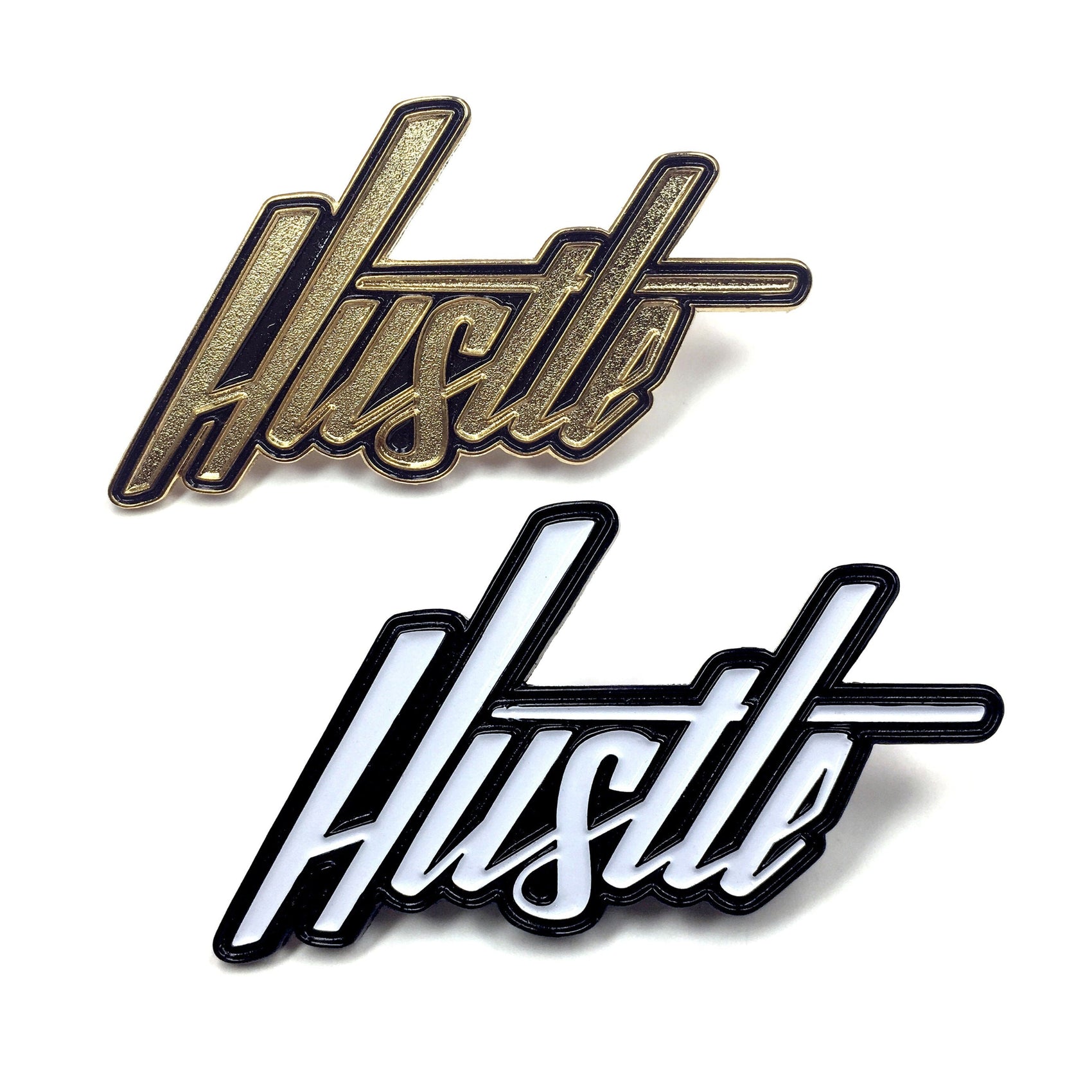 The Kolorspun Hustle Golf Ball Marker set includes two shiny enamel pins—one gold and black, one black and white—with bold, cursive "Hustle" designs. Perfect as a unique golf gift or creative magnetic marker for the green.