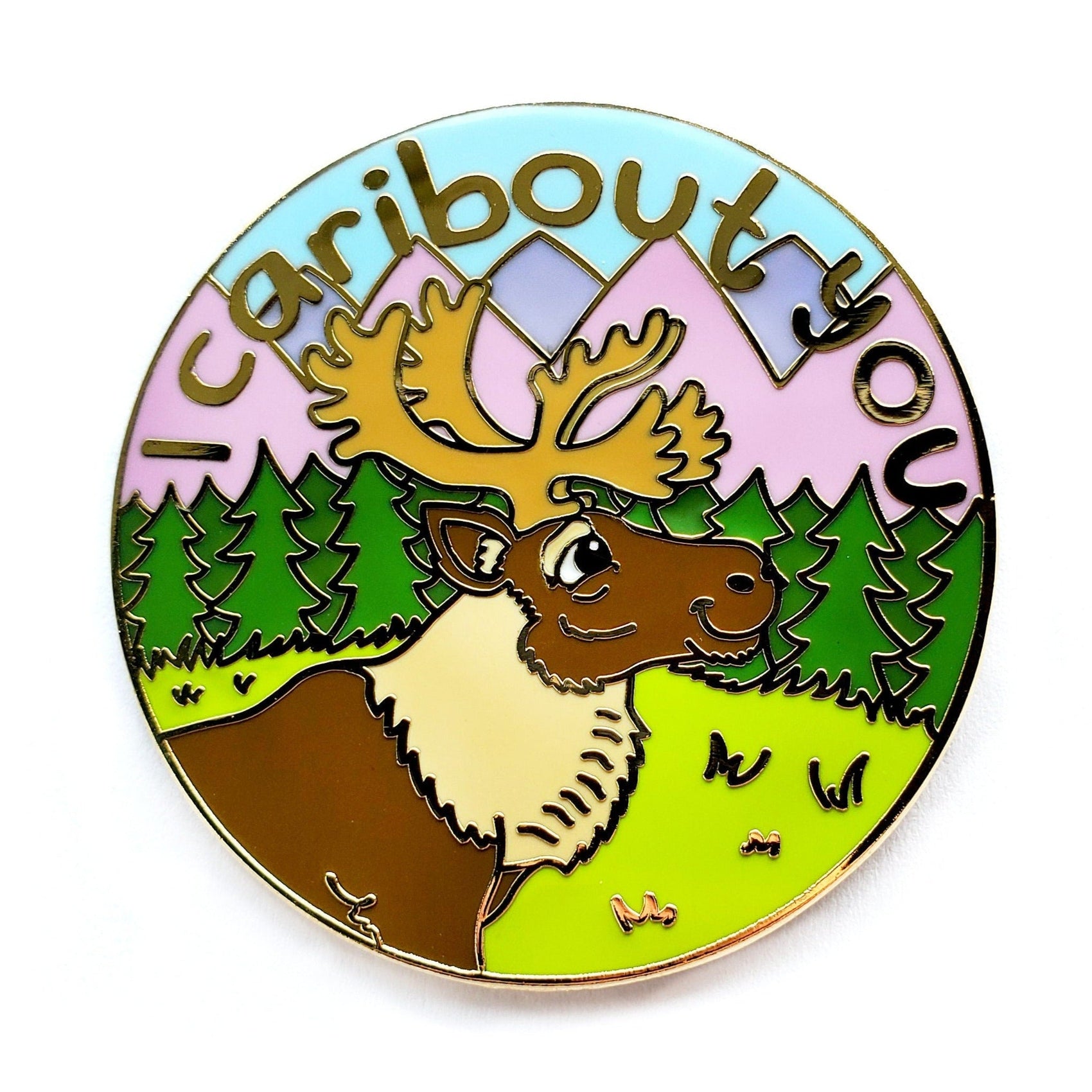 The Kolorspun I Carbout You Golf Ball Marker is a colorful circular pin with a smiling caribou, trees, and mountains, plus playful "I caribout you" text—making it a charming gift for any golf lover.