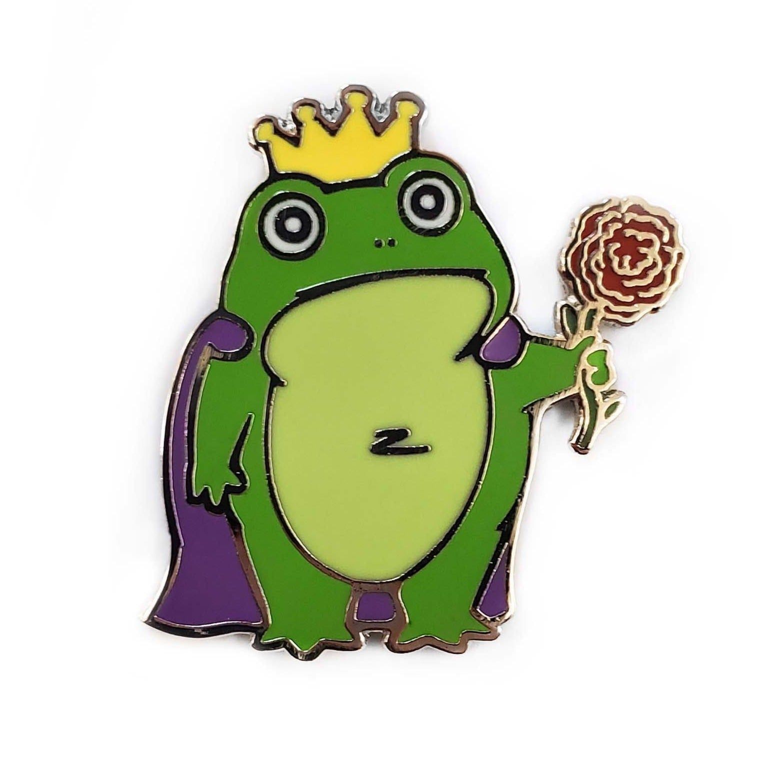 The Kolorspun Frog Prince Golf Ball Marker features a cartoon frog in a yellow crown and purple cape holding a rose, set on a white background—ideal as a unique golf gift or for customizing your game.