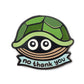The Kolorspun No Thank You Turtle Golf Ball Marker features a cartoon turtle face with big eyes and a green shell above a blue "no thank you" banner—ideal as a fun golf ball marker or unique golf gift.