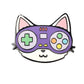 Kolorspun’s Controller Cat Golf Ball Marker features a cartoon cat face with a purple video game controller for eyes and nose, adorned with colorful buttons and a green cross-shaped button, set on a white background.