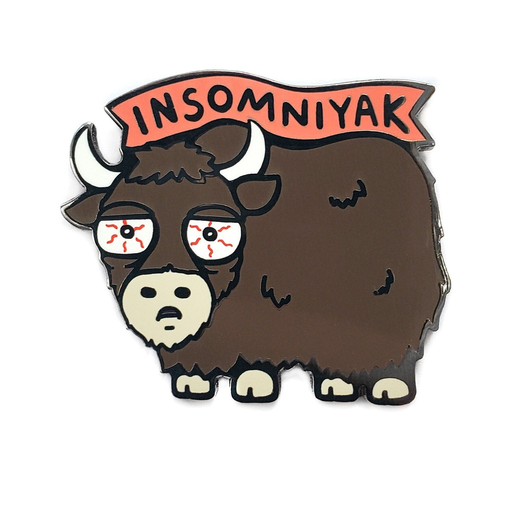 The Kolorspun Insomniyak Pun Golf Ball Marker features a cartoon yak with tired, red eyes and droopy eyelids beneath a red "INSOMNIYAK" banner—perfect as a unique custom golf gift or marker.