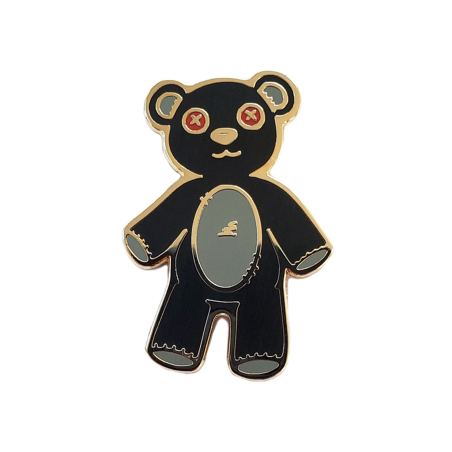 The Kolorspun Teddy Bear Golf Ball Marker features a black bear with red X eyes, a light gray belly, and gold outlines on white. Its magnetic back and unique stitched look make it a cute, quirky golf gift.