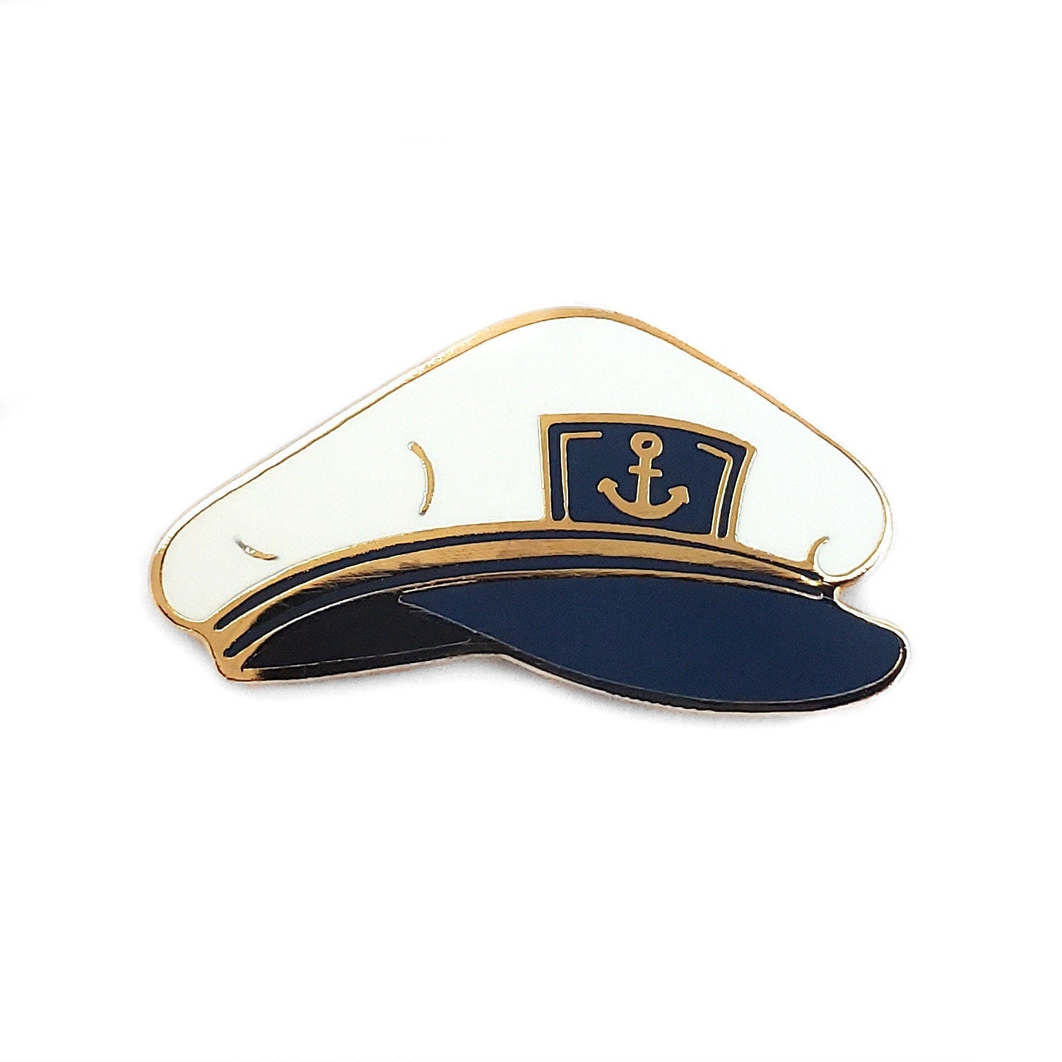 The Kolorspun Captain's Hat Golf Ball Marker is a white and navy blue pin with a gold anchor emblem, serving as both a stylish accessory and magnetic golf ball marker—an ideal and memorable gift for golfers.