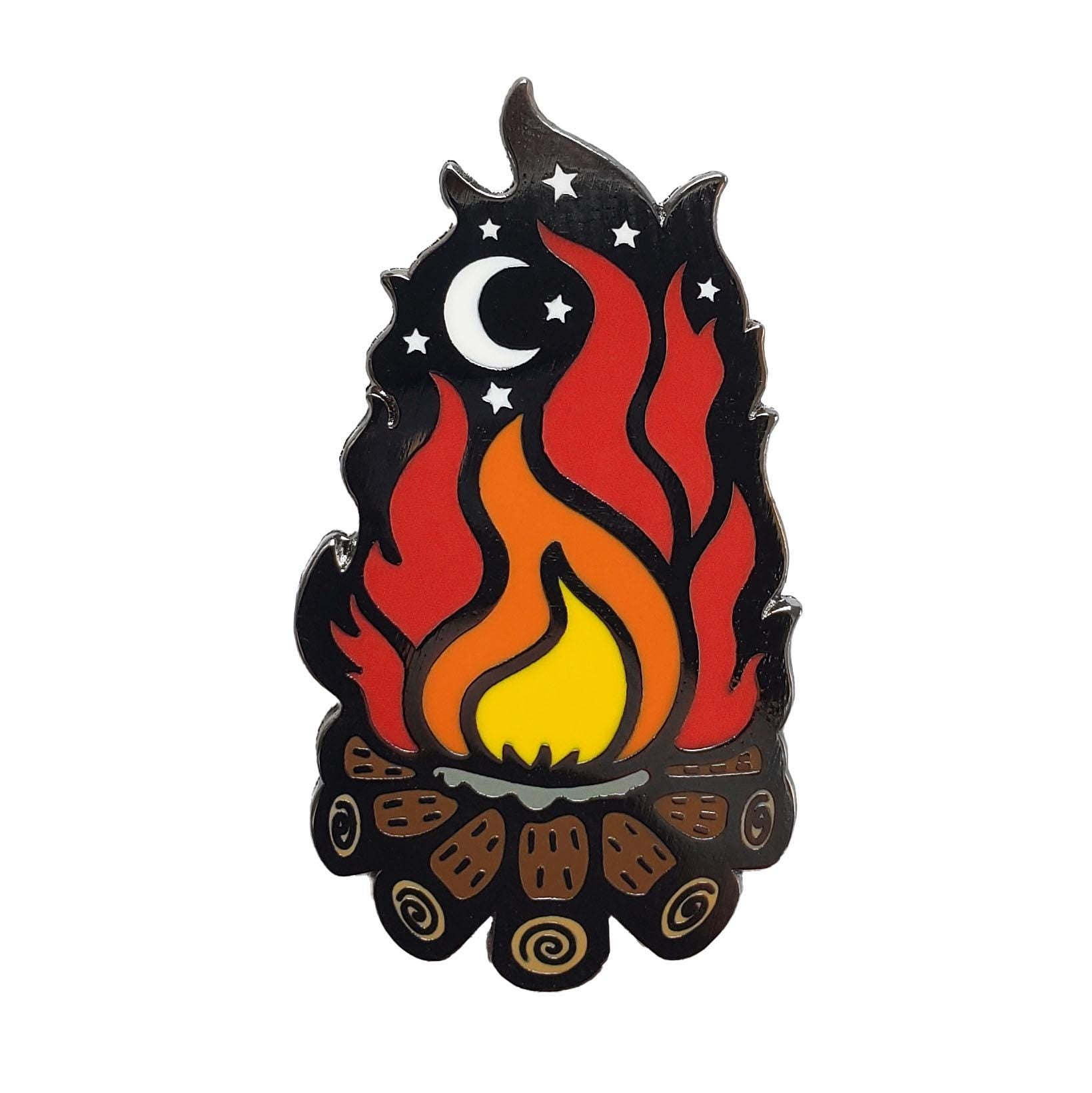 The Kolorspun Campfire Golf Ball Marker features a stylized campfire with yellow and red flames, brown logs, and night sky elements—a unique gift or creative golf accessory for any golfer.