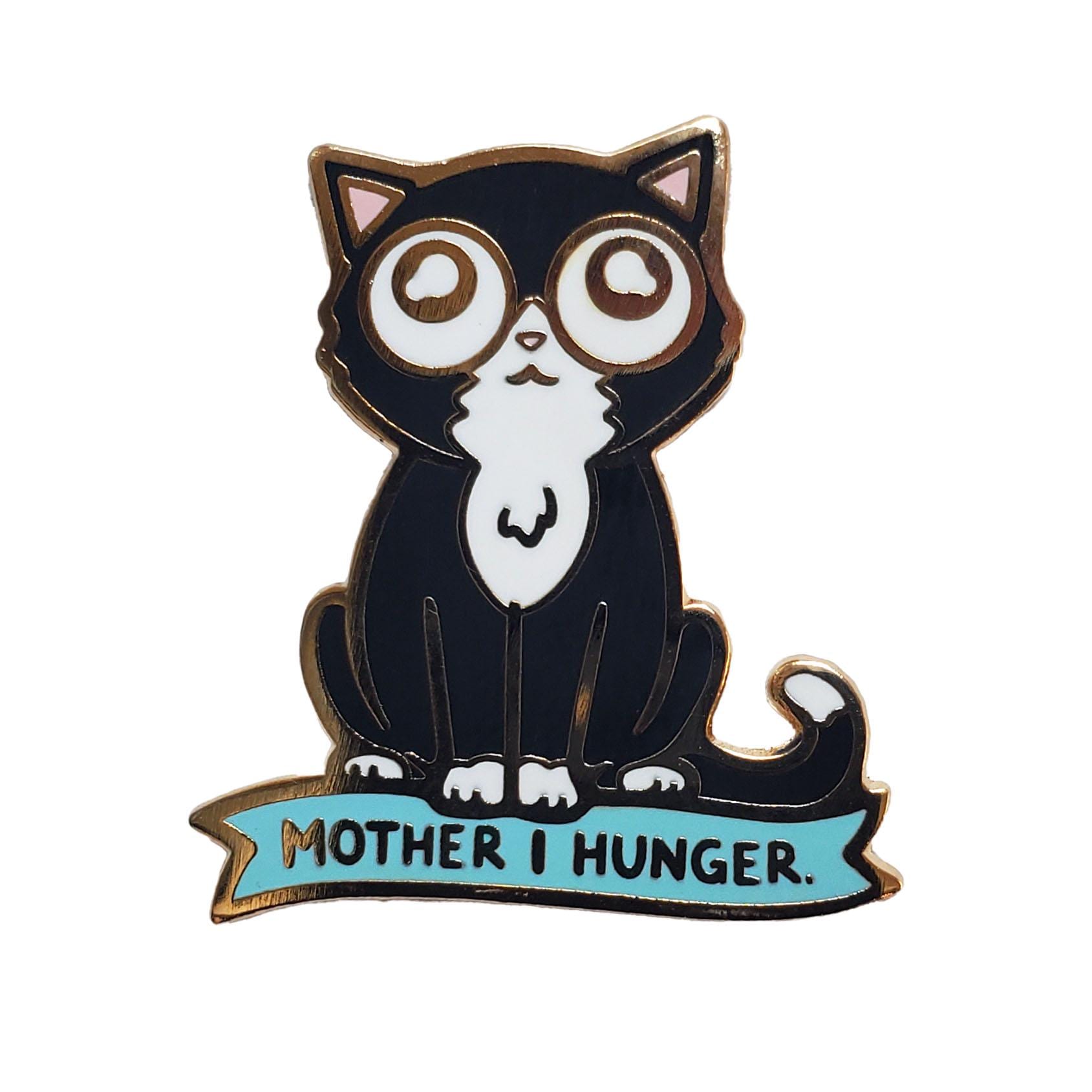 The Kolorspun Hungry Cat Golf Ball Marker features a cartoon black and white cat with wide eyes above a blue "MOTHER I HUNGER" banner—an expectant look makes it the perfect unique golf gift or fun custom marker.