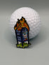 A golf ball sits behind the "UPS Dumpster Fire" enamel pin by Crown Golf Designs, showing a blue mailbox with graffiti and cartoon flames, and featuring a magnetic backing for easy display.