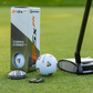 A close-up of a TaylorMade TP5x Pix golf ball with orange and black triangles, a putter, and two OnPointGolf.us Two Rail Ball Markers rests on grass next to the golf ball box.