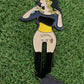 Lady Boy 2.0 by Ballmarkers from Logie Joes is a cartoon pin of a woman with blonde and black hair, black top, and yellow belt. Her dropped skirt reveals a hedgehog—an amusing golf ball marker for those who enjoy quirky accessories.