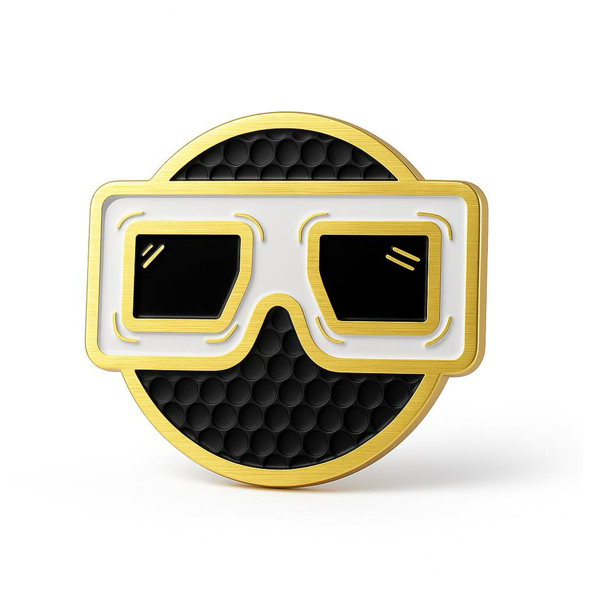 THE BLURRD PREMIUM BALL MARKER by BLURRD is a circular gold golf accessory with a black honeycomb-patterned center and stylized white and gold glasses, featuring magnetic ball marker functionality.