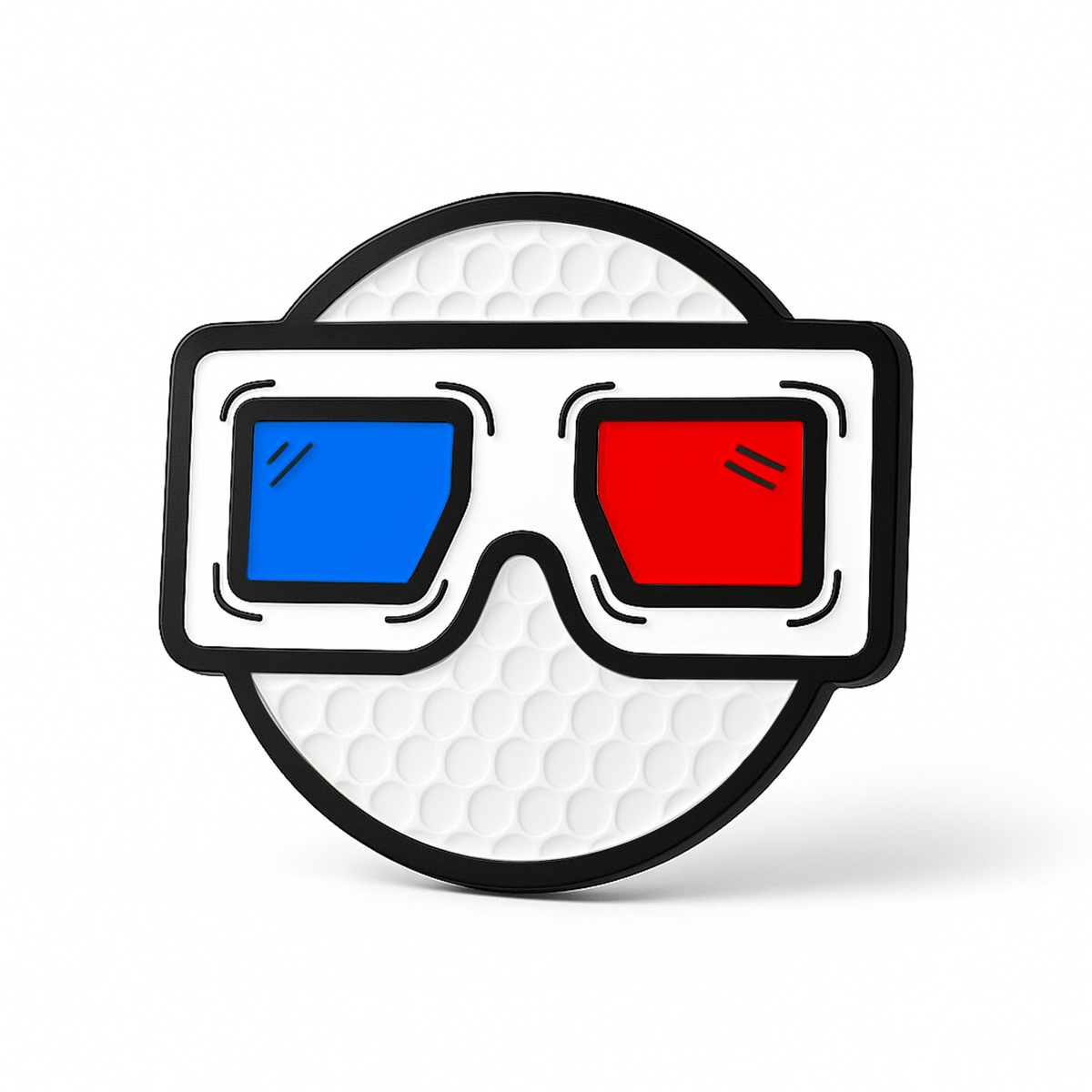 A round, textured white object displays THE BLURRD PREMIUM BALL MARKER by BLURRD—an eye-catching golf accessory featuring black-framed 3D glasses with a blue left lens and a red right lens, set against a plain white background.