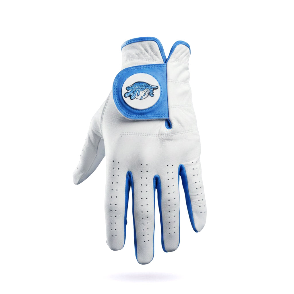 Introducing the Water Ball Cabretta Leather Golf Glove by Logie Joe’s Golf—a premium glove made from supple Cabretta leather. This white glove, accented with blue trim, is displayed palm-down on a white background. Designed for comfort and breathability, it features small ventilation holes and an adjustable wrist strap adorned with a blue Logie Joe’s Golf logo patch. Plus, it includes a convenient magnetic ball marker and is available in left and right hand as well as standard and cadet sizes.